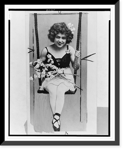 Lillian Leitzel, full-length portrait, seated on high wire swing, facing front, holding flowers, Vintage Poster