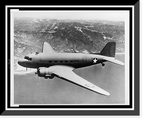 Aerial view of a Douglas C-47 in flight over body of water, with mountains in background, Antique Poster