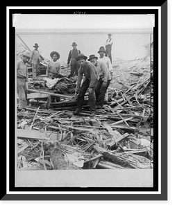 Historic Framed Print, Carrying out bodies just removed from the wreckage, Galveston - 2,  17-7/8" x 21-7/8"