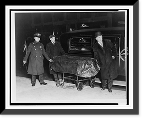 A policeman and two other men, possibly undertakers, with the covered casket of Legs Diamond on a stretcher next to a hearse, Antique Poster