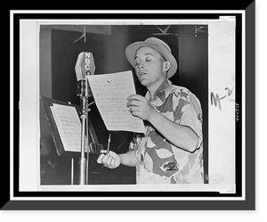 Bing Crosby, half-length portrait, standing at NBC microphone, holding a sheet of music in one hand and a pipe in the other, Historic Reproduction