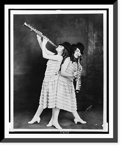 Daisy and Violet Hilton, full-length portrait, holding clarinets, one facing front, the other facing left.National, N.Y, Vintage Poster