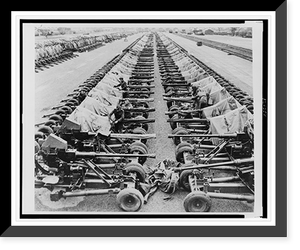 Rows of 40mm Bofors light anti-aircraft(?) guns on Mark II mountings sitting beside railroad tracks in England, in preparation for Allied liberation of Europe, Antique Print