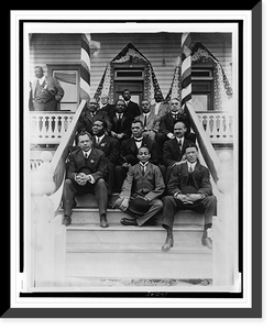Booker T. Washington, seated on steps, with group of other men, outside of building, Vintage Poster