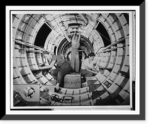 Women workers install fixtures and assemblies to a tail fuselage section of a B-17 bomber at the Douglas Aircraft Company plant, Long Beach, Calif, Historic Reproduction