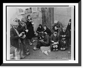 French refugees of the town of the Corcieux, France, eat their noon meal in a courtyard.Signal Corps U.S. Army. Classic, Antique Print