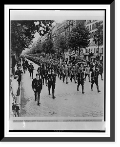 A large number of German prisoners march through the streets of Paris, led by and under the guard of French police, enroute to a prisoner-of-war camp, Vintage Poster