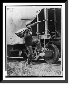 Lou Ambers with a large bag over his shoulder, mounting the ladder of a train car.Staff photo by Alan Fisher, Historic Print