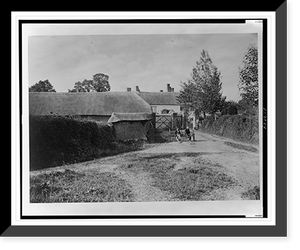 Rural scene (England?), men posed on farm equipment at entrance to farm complex, Vintage Print