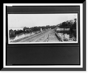 Historic Framed Print, [Workers laying sandbags between railroad tracks and flooded area, seawall and sandbag levee contain flood waters that have already partially submerged utility poles].Ewing, Inc., Baton Rouge.,  17-7/8" x 21-7/8"