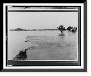 Floodwater covering vast area submerging vegetation and damaged building.Ewing, Inc, Historic Print