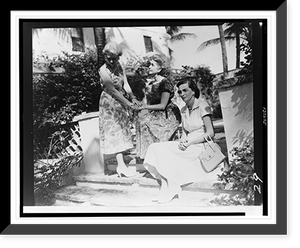 Barbara Hutton, seated (center), with two women on steps outside house, Historic Reproduction