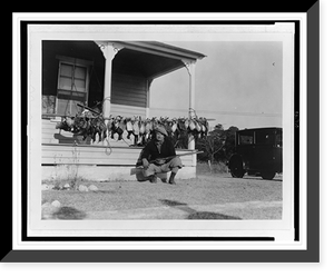 Historic Photo Print - Man squatting with rifle across lap