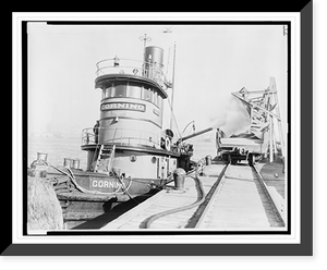 Historic Framed Print, [Ashes from the stokehold of a tugboat are blown into a railroad freight car at dockside].World Telegram & Sun photo by Roger Higgins.,  17-7/8" x 21-7/8"