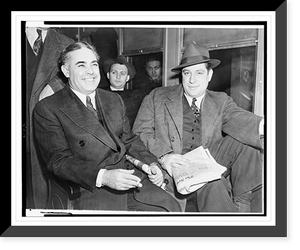 Historic Framed Print, [Louis Capone, left, and Emanuel Mendy" Weiss holding a copy of the New York Times,  three-quarter length portrait,  seated].World Telegram photo by Al Aumuller.",  17-7/8" x 21-7/8"