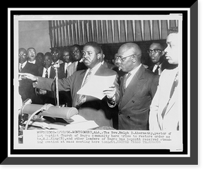 Historic Framed Print, [Reverend Ralph D. Abernathy attempting to calm the audience at the First Baptist Church following a standing ovation for leaders of the bus boycott],  17-7/8" x 21-7/8"