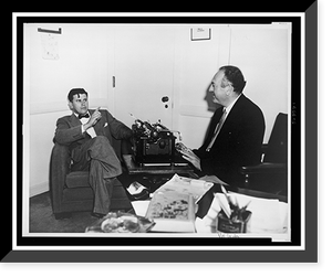 Historic Photo Print - Val Lewton sits at his typewriter and converses