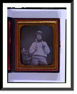 Occupational portrait of a carpenter, three-quarter length, seated, facing front, holding hammer and nail, on a chair at his side are a saw, box plane, and measuring device - 2 Timeless Wall Art