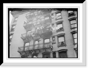 Historic Framed Print, Tenement dwellers dropping clothes from fire escape for Italians on East side, New York,  17-7/8" x 21-7/8"
