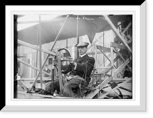 Historic Framed Print, Dr. Wm. Greene at pilot wheel of aeroplane,  17-7/8" x 21-7/8"