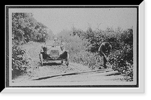 Black & White Photo - Man clearing roadside brush