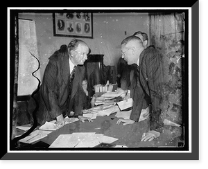 Historic Framed Print, Eye to eye. Washington, D.C., Dec. 18. George Whitney, a partner in the J.P. Morgan Co., being questioned by Chairman Burton K. Wheeler at the Senate Railroad Financing Inquiry today,  17-7/8" x 21-7/8"