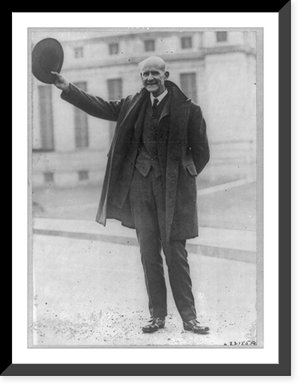 Eugene Victor Debs, 1855-1926, full-length portrait, standing, holding hat in air, facing left, outside of Federal Penitentiary, Atlanta, Ga, Historic Print