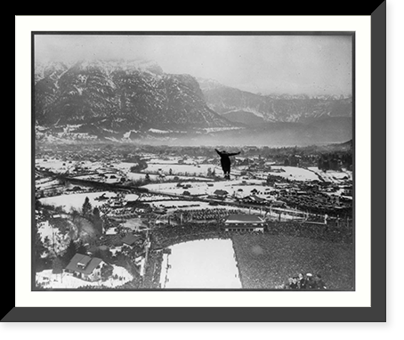 Winter Olympic games at Garmisch, Germany. 1936: view from top of ski-jump; jumper in mid-air, Vintage Print