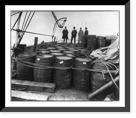 Historic Framed Print, [Coast Guard Cutter, USS Seneca chasing and capturing a rum runner" 1924: Prohibition agents examining barrels on boat]",  17-7/8" x 21-7/8"