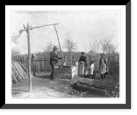 Negro man, woman and three children at an old-time well, Antique Poster