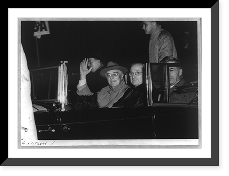 Franklin D. Roosevelt, bust, seated in car, waving, facing slightly left, with Harry Truman and unidentified person returning to Washington on Nov. 10, 1944, Historic Print
