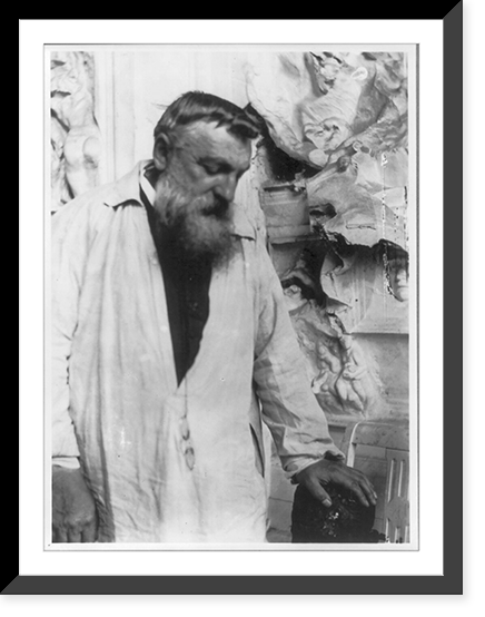 Auguste Rodin, 1840-1917, three quarters length portrait, face looking down, facing right, hand on sculpture. Taken in Meudon, France, about 1906, Vintage Wall Art