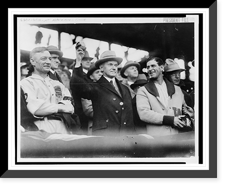 Calvin Coolidge, half length, standing, facing slightly right, holding up baseball at baseball game prior to opening game, 1925. L.to R.: Bill McKechnie, Coolidge, Bucky Harris Classic Wall Art P