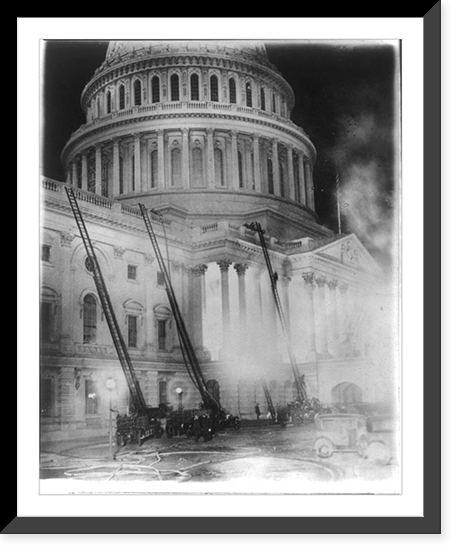 View of the U.S. Capitol during the fire which destroyed the studio of Artist Chas. Moberly & considerably damaged the House Document Room - fire engines with ladders going up the side of the Capit