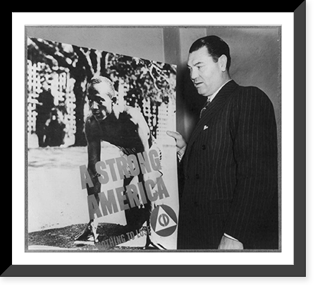 Jack Dempsey, 1895- , posed with Civil Defense poster A Strong America" showing Jesse Owens on starting blocks", Vintage Poster