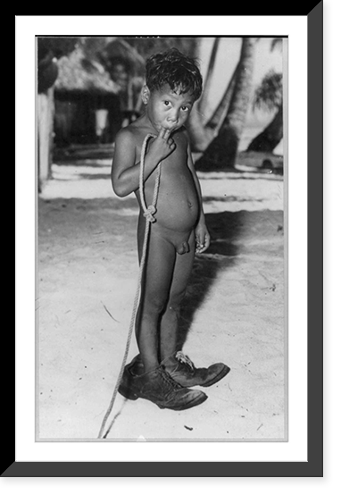 Natives of Bikini Island before atomic bomb test: naked boy wearing very large shoes, Historic Print