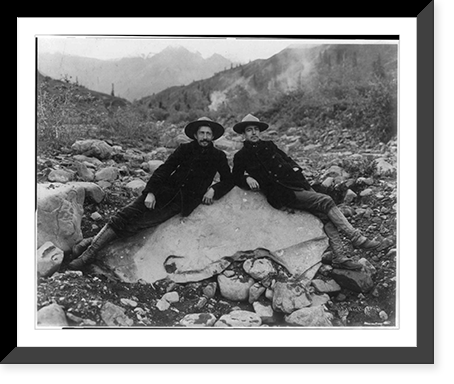 Two men recining on a large nugget of pure native copper in the bed of Nugget Creek, Valdez vicinity, Alaska Classic, Historic Reproduction