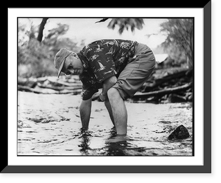 James Michner in Hawaii, May 1954: bent over in shallow water with pants rolled up, Antique Poster