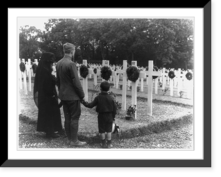 Soldier, woman, and boy paying respects at a grave in a military cemetery, Antique Print