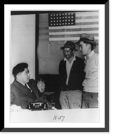 Historic Framed Print, Los Angeles, Calif. - curfew - Fred Tayama, chairperson of the Southern District Council of the Japanese American Citizens League explaining curfew and travel laws to two fellow Japanese,  17-7/8" x 21-7/8"