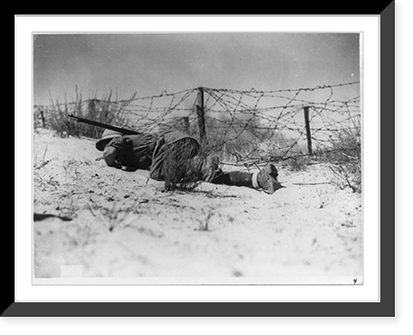 Historic Framed Print, [Infantryman in desert gear crawling under barbed wire],  17-7/8" x 21-7/8"