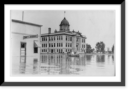 Rosebud County Court House, Forsyth, Mont., surrounded by flood waters; people in canoe, Antique Poster