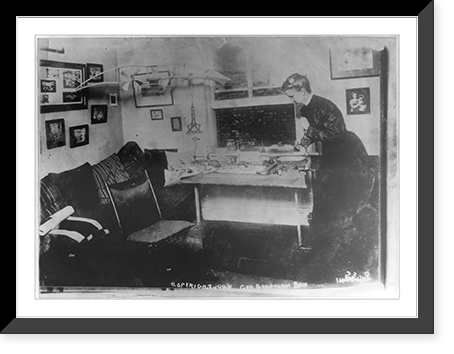 E. Lillian Todd standing at table, Vintage Poster