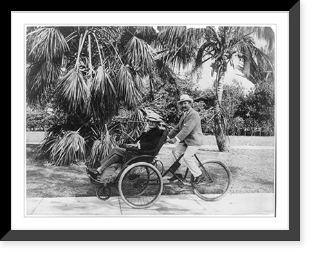 Joe Jefferson on seat on front of quadricycle being peddled by another man, Palm Beach, Fla. Classic, Vintage Poster