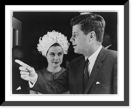John F. Kennedy and Grace Kelly. Both half lgth. Grace Kelly looking at John Kennedy, who is pointing with his right hand, Vintage Print