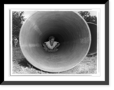 Historic Framed Print, [The Big Inch pipeline under construction: Man cleaning pipe from inside before the welders join the pipe],  17-7/8" x 21-7/8"