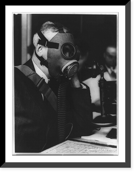 Col. Charles R. Alley, of the Chemical Warfare Service Division of the Army, carrying on a telephone conversation while wearing a newly developed gas mask, Vintage Poster