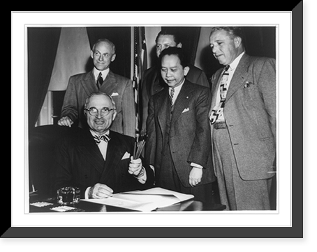 Good new for the Philippines. President Truman holds souvenir pens used in the signing ceremony of the Philippine Rehabilitation and Trade Bill at the White House after the signing Classic Wall Art