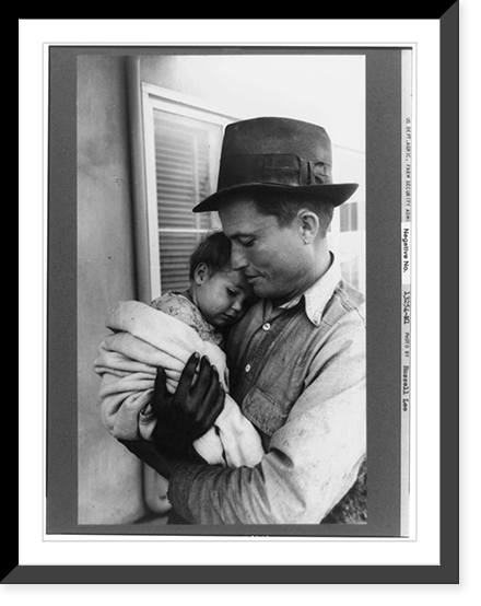 Eleven Mile Corner, Ariz., Feb. 1942. Farm Security Administration migratory workers' community. Father with his baby waiting to see the doctor at the clinic of the Cairn General Hospital Heritage