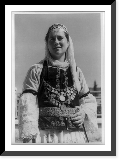 Albanian woman in elaborate dress, half-length, standing, facing left, Vintage Poster